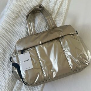 Brand new Calpak gold Luka Duffle bag